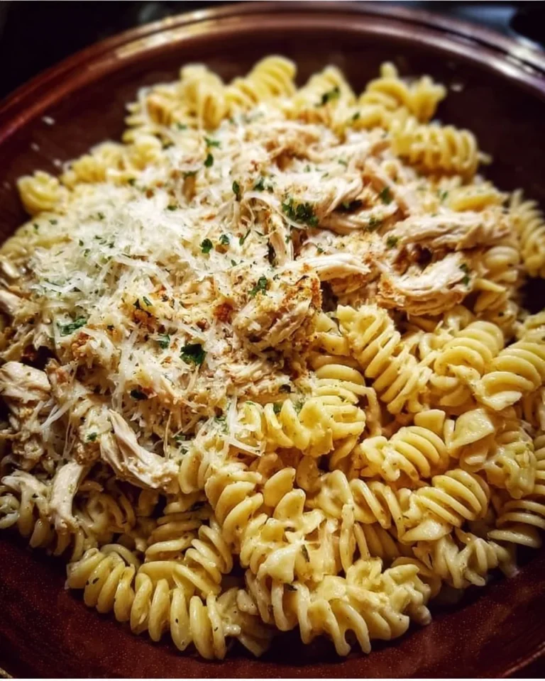 Crockpot Garlic Parmesan Chicken Pasta in a bowl garnished with parsley.