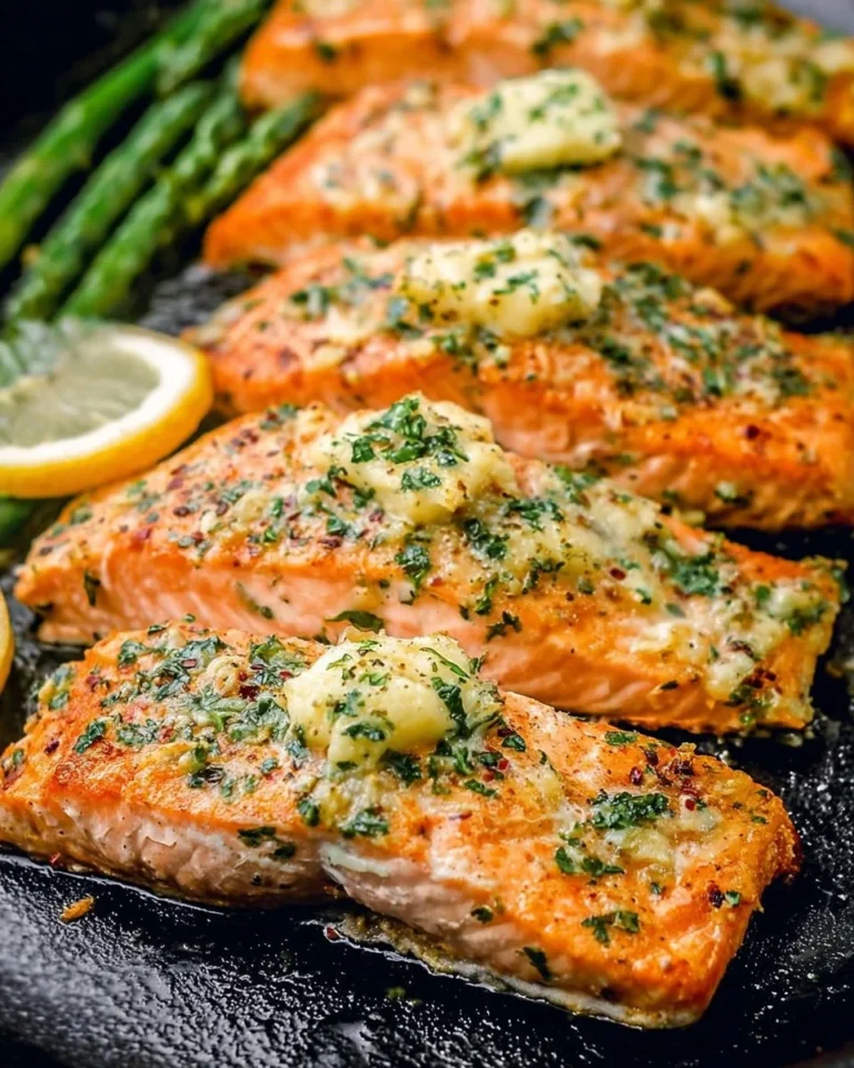 Delicious garlic butter baked salmon fillet served with lemon slices and herbs