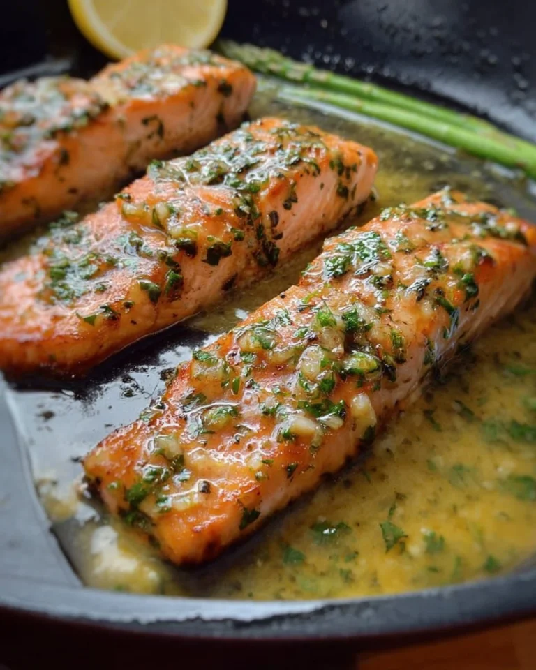Garlic Butter Salmon garnished with herbs and lemon slices