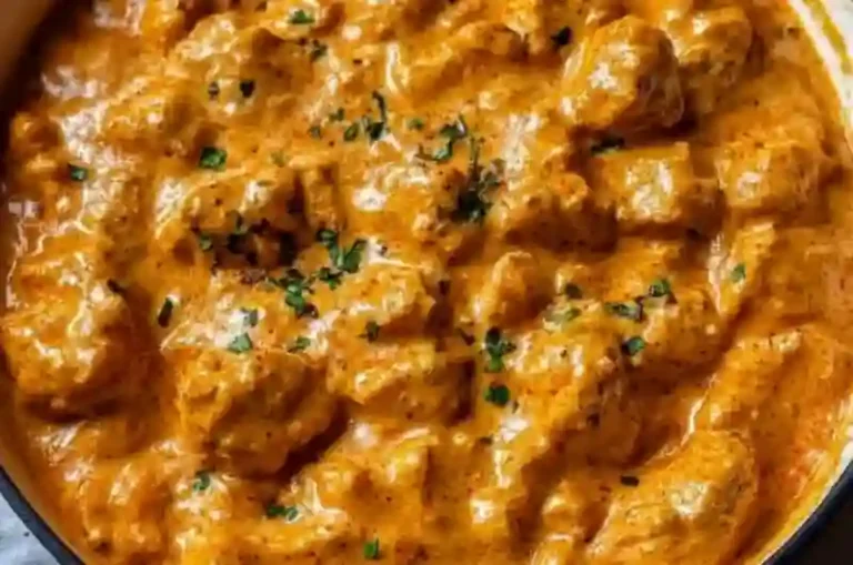 Delicious butter chicken served with rice and naan bread