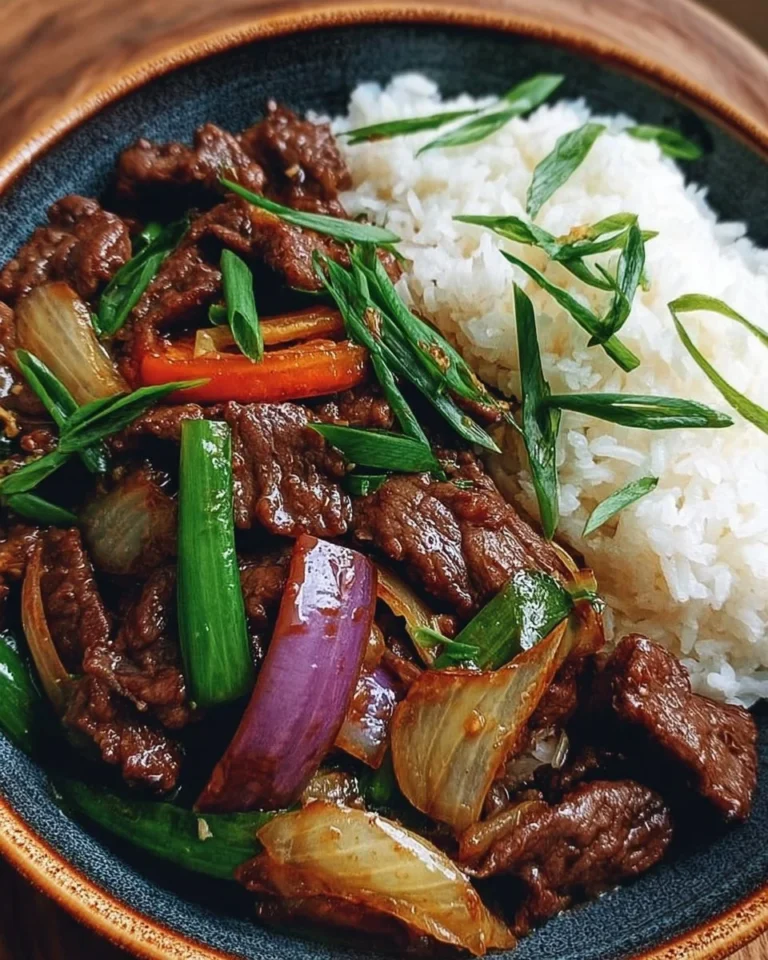 Chinese beef and onion stir fry dish served in a bowl