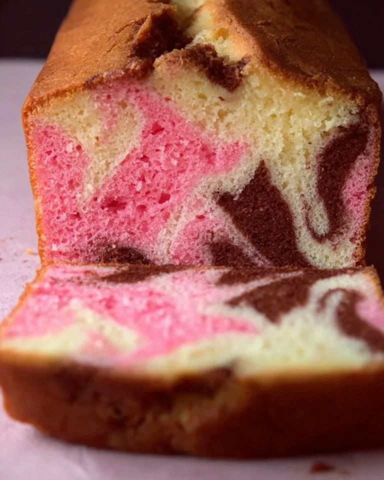 Deliciously baked Pink Marble Cake with swirls of pink and white frosting