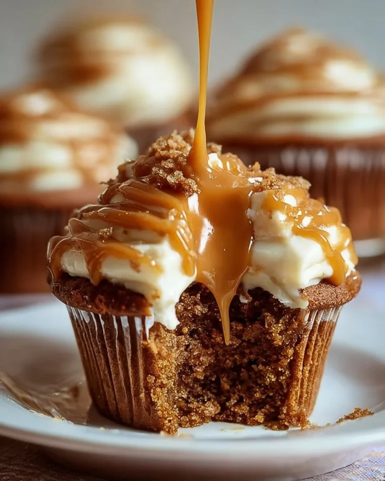 Rich sticky toffee pudding cupcakes topped with caramel sauce and whipped cream
